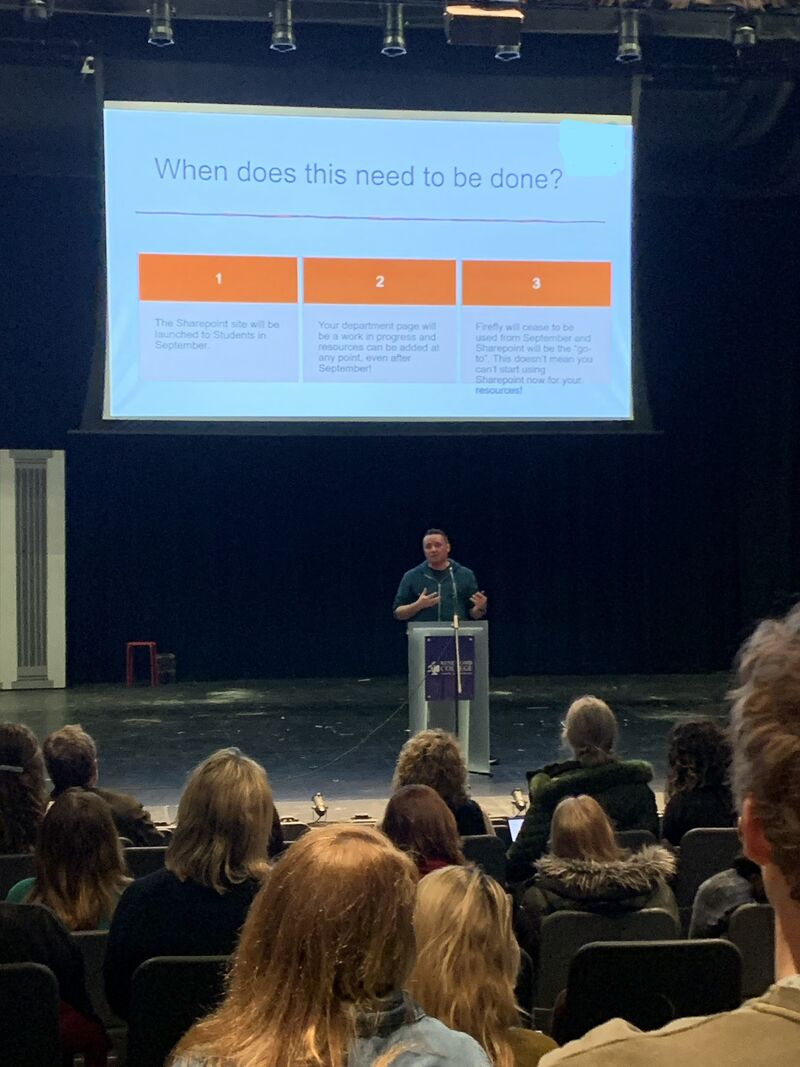 A photo of a person delivering an INSET training session to teachers.